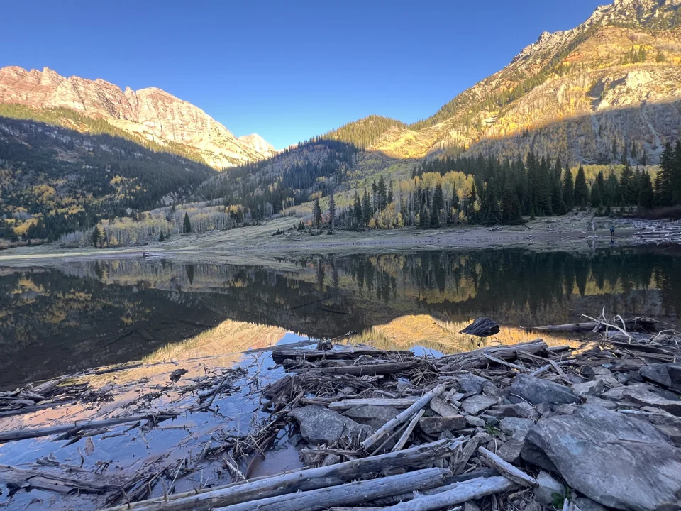 Mountain reflections and exposed shoreline at Crater Lake in October