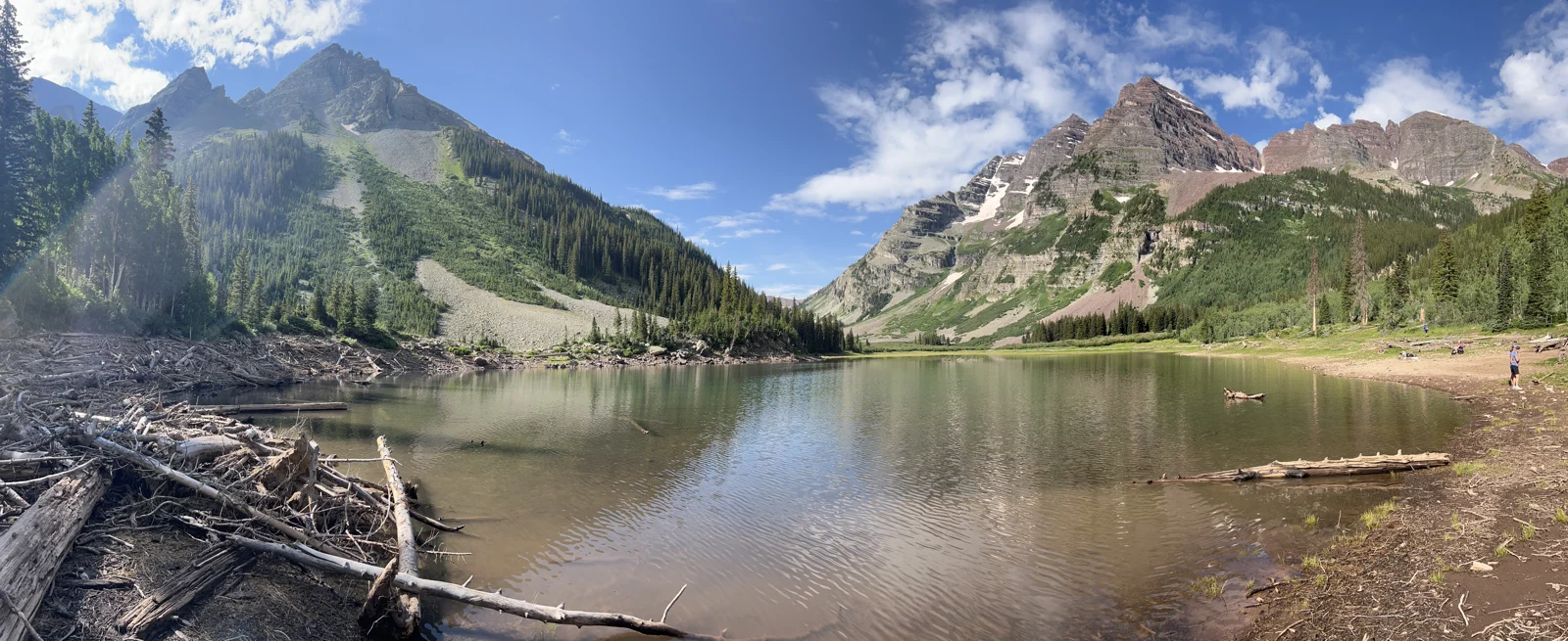 Wide July panorama of Crater Lake and surrounding mountains
