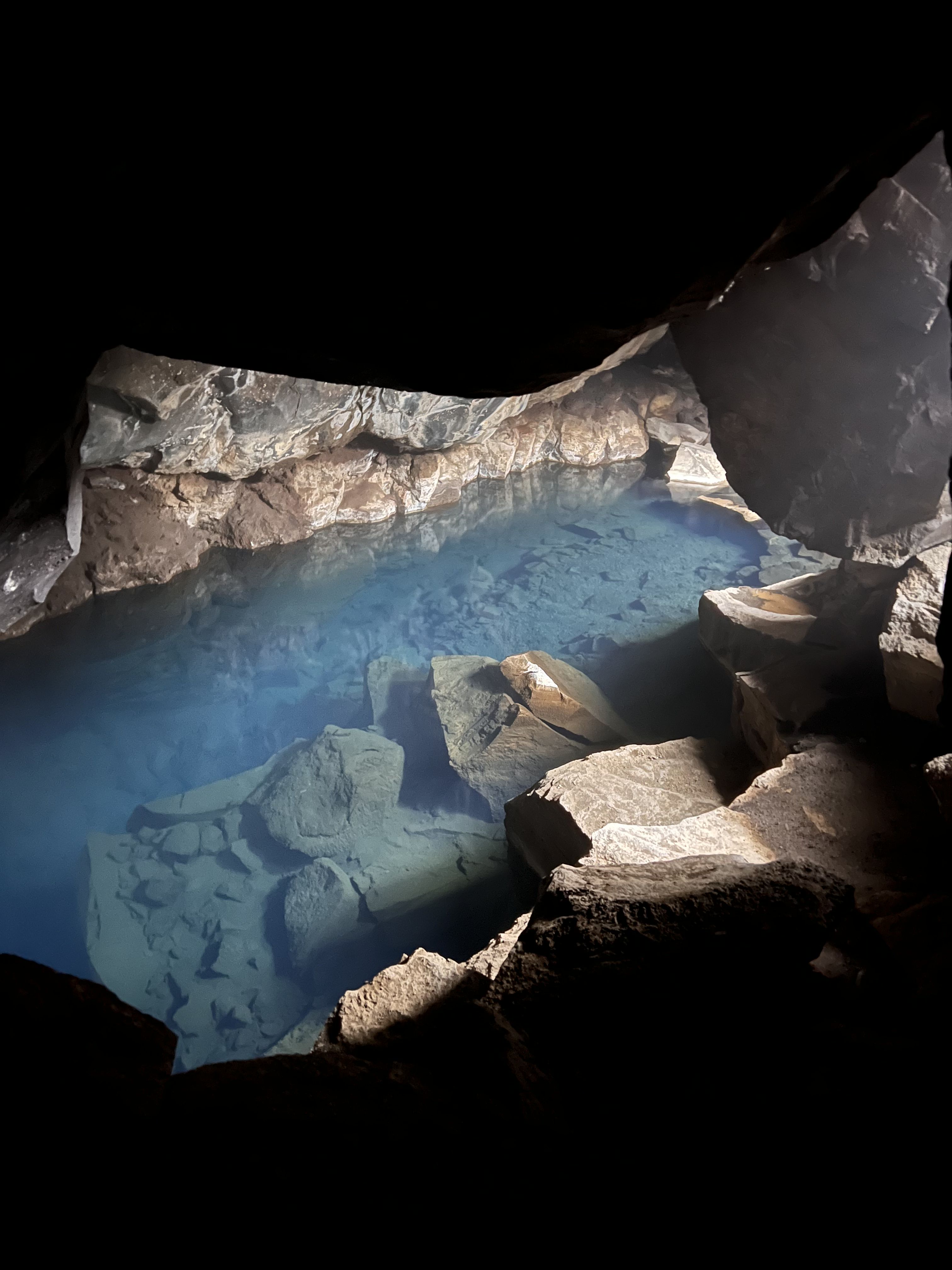 Blue geothermal water inside Grjótagjá lava cave