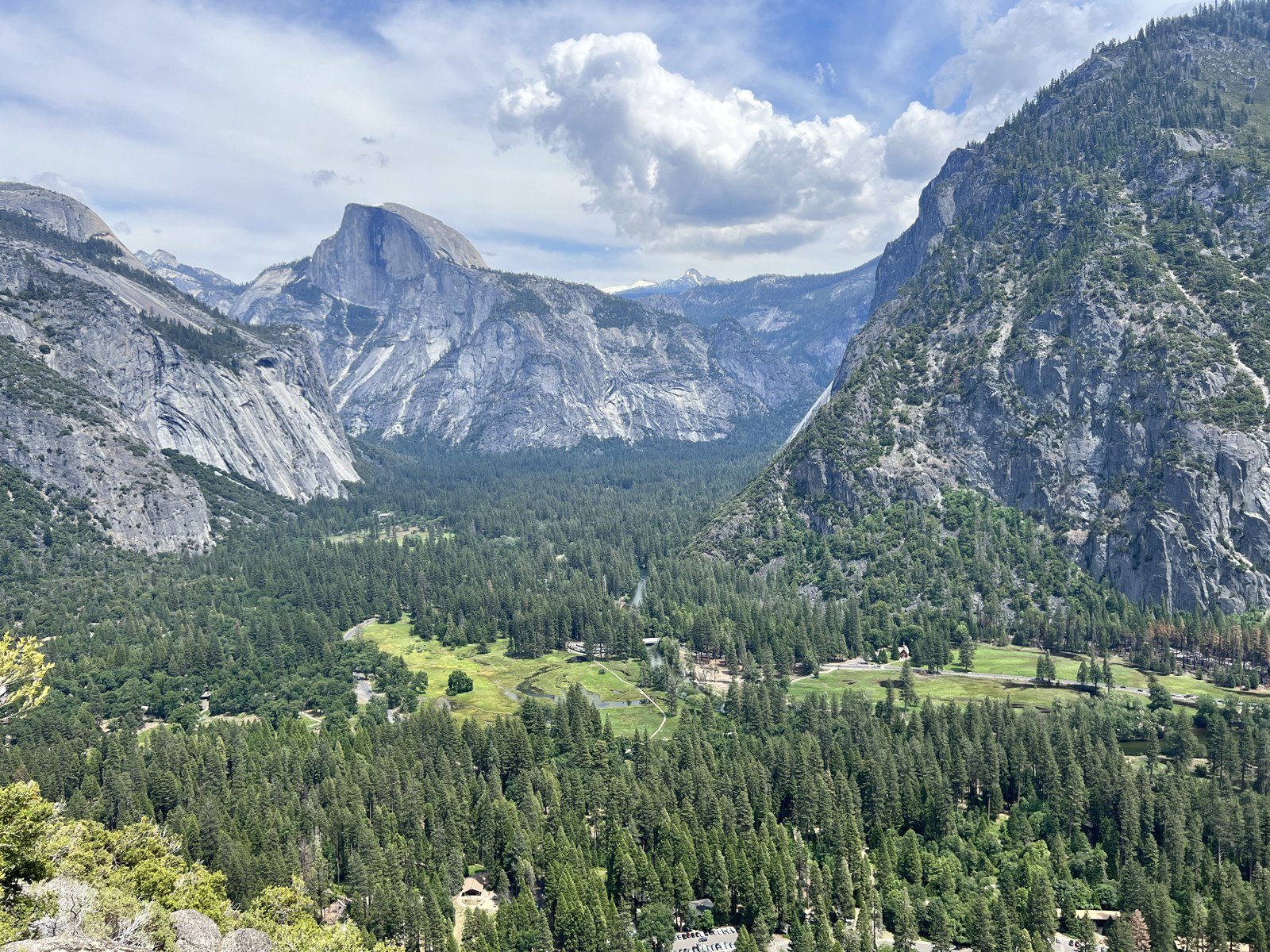 Half Dome and Yosemite Valley beneath clouds in June 2023